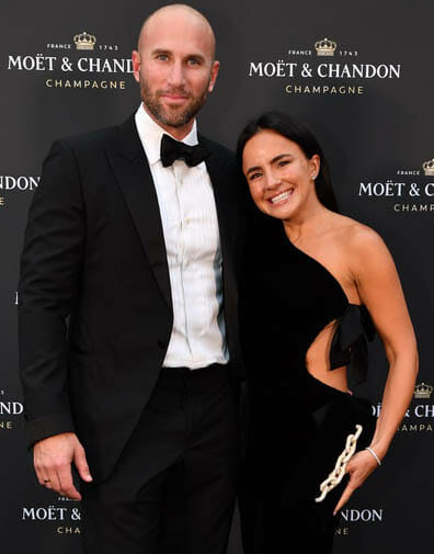 Female entrepreneur and husband attend business awards event in glamorous black formal attire