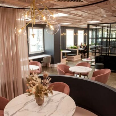 beauty academy luxurious pink foyer features chic curtains, marble study desks with vases and golden chandeliers