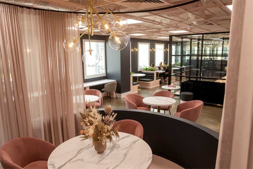 beauty academy luxurious pink foyer features chic curtains, marble study desks with vases and golden chandeliers