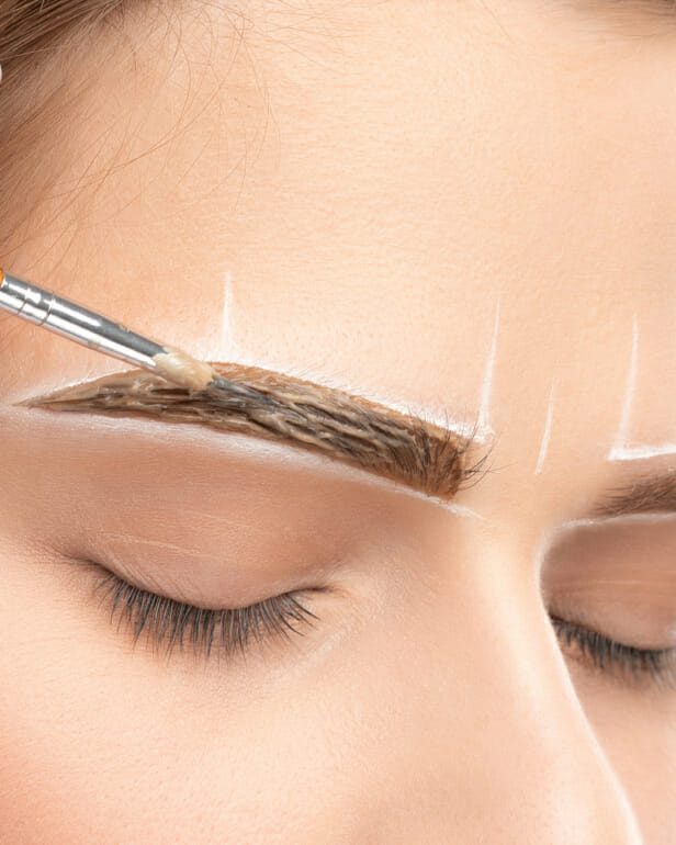 Make Up Artist Makes Markings With White Pencil For Eyebrow And Paints Eyebrows. Professional Makeup And Facial Care.