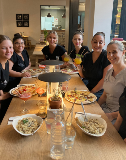 students and teacher eating Italian food