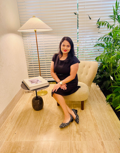 Women sitting in a chair wearing a black dress