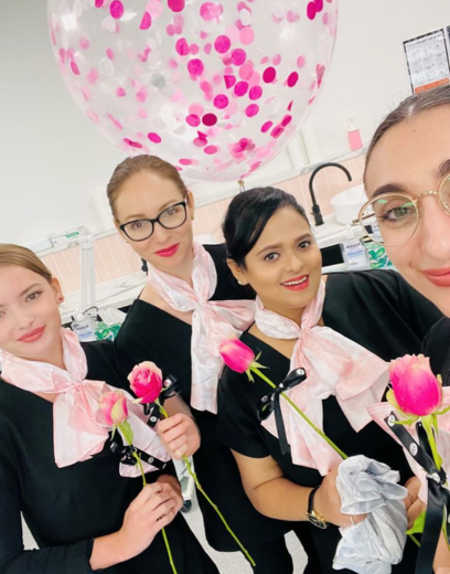 girls holding pink roses with pink scarves